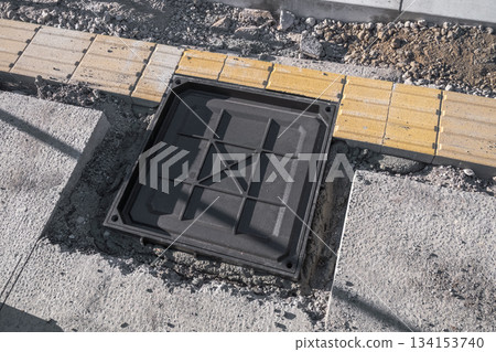 Installation of braille blocks and decorative iron covers 134153740