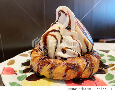 Danish pastry topped with soft serve ice cream. Crispy and fluffy bread with soft serve ice cream. Danish pastry topped with soft serve ice cream. Crispy and fluffy bread with soft serve ice cream. 134153925