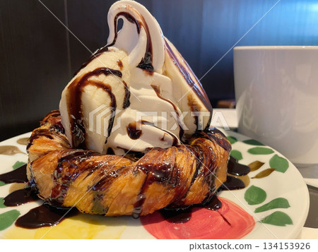 Danish pastry topped with soft serve ice cream. Crispy and fluffy bread with soft serve ice cream. Danish pastry topped with soft serve ice cream. Crispy and fluffy bread with soft serve ice cream. 134153926