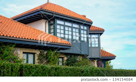 Beautiful traditional house in Northern Spain featuring a red terracotta tiled roof 134154084