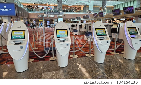 Changi Airport sleek terminal glows with modern lighting, self-service kiosks Changi Airport sleek terminal glows with modern lighting, self-service kiosks 134154139