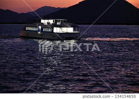 Safety first at night! Ferry heading to a remote island Safety first at night! Ferry heading to a remote island 134154650