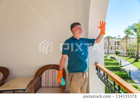 Happy Man on His Balcony Joyfully Greeting Neighbors, Embracing Community Spirit and Connection in a Bright, Welcoming Home Environment Happy Man on His Balcony Joyfully Greeting Neighbors, Embracing Community Spirit and Connection in a Bright, Welcoming Home Environment 134155378