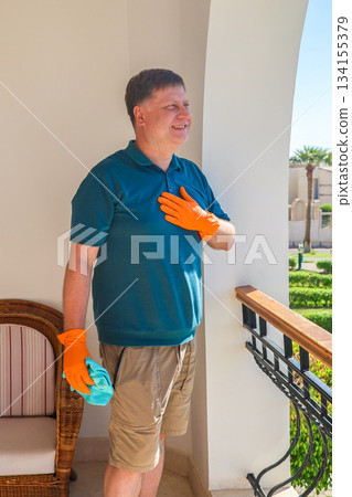 Happy Man on His Balcony Joyfully Greeting Neighbors, Embracing Community Spirit and Connection in a Bright, Welcoming Home Environment 134155379