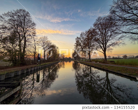 Rijkevorsel, Antwerpse Kempen, Belgium, Calm reflective water scene during sunset with trees and 134155520