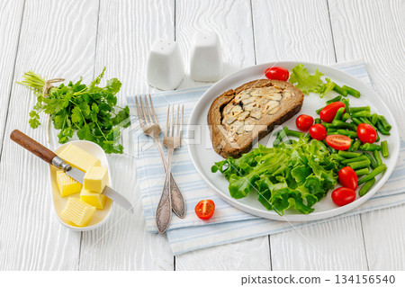 Finnish Kalakukko, fish pie on plate with veggies Finnish Kalakukko, fish pie on plate with veggies 134156540