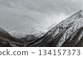 Snowy mountain landscape with dramatic clouds and valley view 134157373