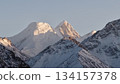 Majestic snow-capped mountains under soft morning light with peaks 134157378