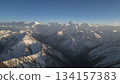 Snow-covered mountain range under clear blue sky with dramatic peaks 134157383