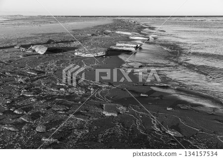 Black and white landscape photography featuring ice floes mixed with sand Black and white landscape photography featuring ice floes mixed with sand 134157534