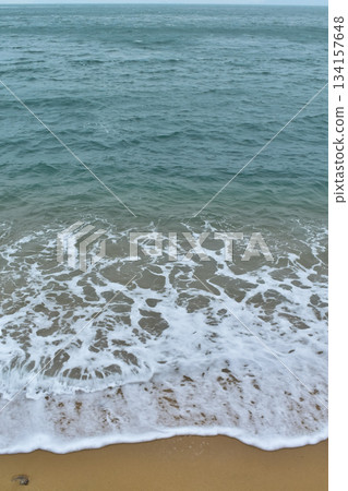 Close-up of soft waves sand beach and blue sea. Texture of water, white foam waves. Seascape, Sea background, Sea water with copy space, summer vacation concept.  134157648