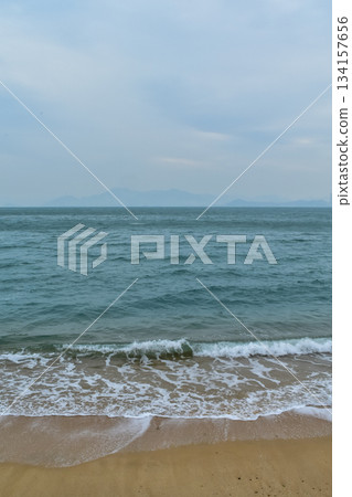 Close-up of soft waves sand beach and blue sea. Texture of water, white foam waves. Seascape, Sea background, Sea water with copy space, summer vacation concept. Close-up of soft waves sand beach and blue sea. Texture of water, white foam waves. Seascape, Sea background, Sea water with copy space, summer vacation concept. 134157656