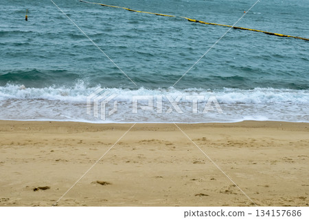 Close-up of soft waves sand beach and blue sea. Texture of water, white foam waves. Seascape, Sea background, Sea water with copy space, summer vacation concept. Close-up of soft waves sand beach and blue sea. Texture of water, white foam waves. Seascape, Sea background, Sea water with copy space, summer vacation concept. 134157686