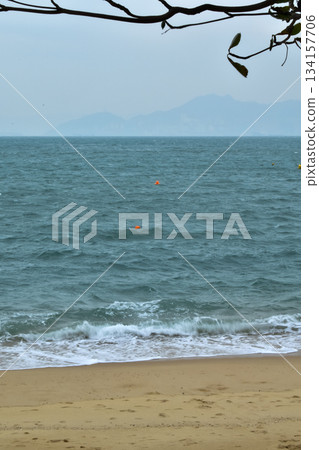 Close-up of soft waves sand beach and blue sea. Texture of water, white foam waves. Seascape, Sea background, Sea water with copy space, summer vacation concept. Close-up of soft waves sand beach and blue sea. Texture of water, white foam waves. Seascape, Sea background, Sea water with copy space, summer vacation concept. 134157706