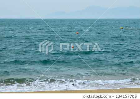 Close-up of soft waves sand beach and blue sea. Texture of water, white foam waves. Seascape, Sea background, Sea water with copy space, summer vacation concept.  134157709