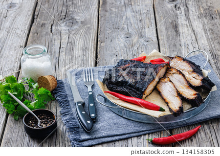 charred pork chunk served on a metal tray charred pork chunk served on a metal tray 134158305
