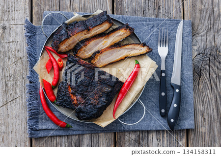 charred pork chunk served on a metal tray charred pork chunk served on a metal tray 134158311