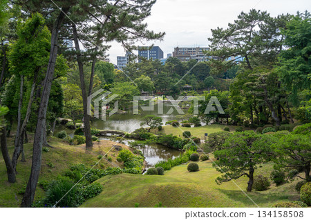 Traditional Shukkei-en Japanese garden with pond in Hiroshima, Japan Traditional Shukkei-en Japanese garden with pond in Hiroshima, Japan 134158508