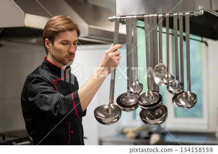 Male cook working in professional kitchen 134158559