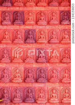 A bas-relief with multiple Buddha figures in Nanshan Park, Sanya, Hainan. 134159053