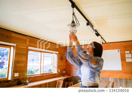 Woman adjusting the lighting 134159058