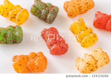 Colorful gummy bears with chili lime seasoning displayed on clean white plate Colorful gummy bears with chili lime seasoning displayed on clean white plate 134159260
