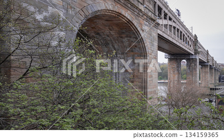 Perspective of The High level bridge is a road and railway bridge spanning the River Tyne connecting Newcastle upon tyne and Gateshead. Perspective of The High level bridge is a road and railway bridge spanning the River Tyne connecting Newcastle upon tyne and Gateshead. 134159365