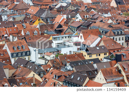 Scenic aerial view patchwork of Heidelberg red rooftops tiled roofs historical colorful houses medieval old city German Baden-Wurttemberg. Abstract texture charm historic old town architecture Scenic aerial view patchwork of Heidelberg red rooftops tiled roofs historical colorful houses medieval old city German Baden-Wurttemberg. Abstract texture charm historic old town architecture 134159409