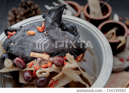 A revered staple in Chinese and Asian culinary traditions, the nourishing health stew pictured is widely celebrated as "Black Chicken Soup". 134159565