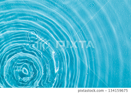 drops on water with circles on a blue background drops on water with circles on a blue background 134159675