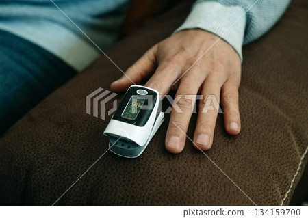 man measuring his blood oxygen saturation 134159700