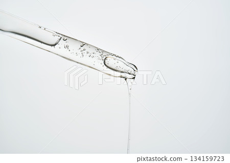 Cosmetic pipette dispensing serum with bubbles and liquid dripping Cosmetic pipette dispensing serum with bubbles and liquid dripping 134159723