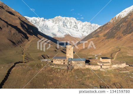 medieval Georgian church on the background of the peak of Shkhara 134159780