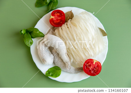 Raw rice noodles and frozen shrimp with tomato and basil 134160107