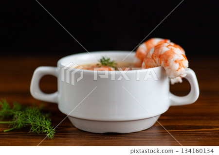 Creamy shrimp soup served warmly with fresh herbs garnish Creamy shrimp soup served warmly with fresh herbs garnish 134160134