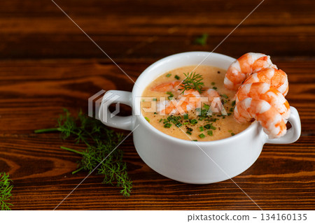 Delicious creamy shrimp bisque presented in white ceramic cup Delicious creamy shrimp bisque presented in white ceramic cup 134160135