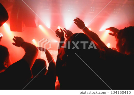 Crowd raising hands at music event Crowd raising hands at music event 134160410