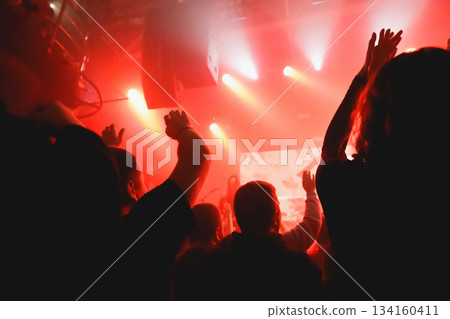 Crowd raising hands at music event Crowd raising hands at music event 134160411