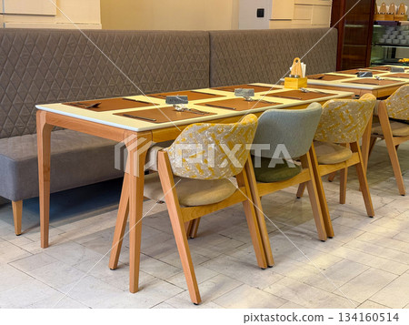 Reserved table in modern cafe interior. Hospitality, dining culture, social meeting space and comfortable seating atmosphere. 134160514