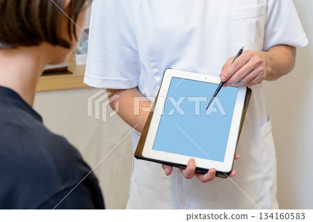 Medical staff pointing at tablet screen Medical staff pointing at tablet screen 134160583