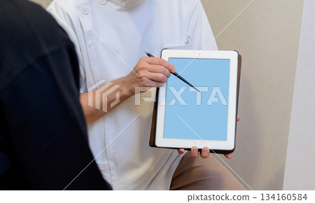 Medical staff pointing at tablet screen 134160584