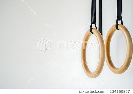 Wooden Gym Rings Hanging in the Empty Space, Close-up Wooden Gym Rings Hanging in the Empty Space, Close-up 134160867