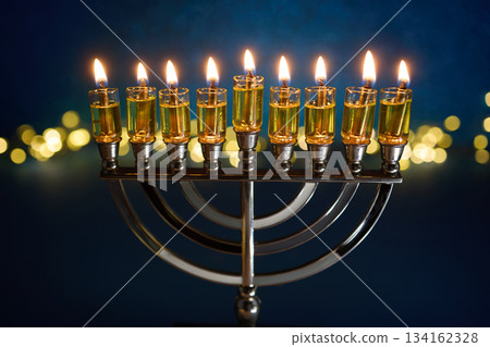 Hanukkah Glowing Menorah. A lit menorah against a vibrant blue 134162328