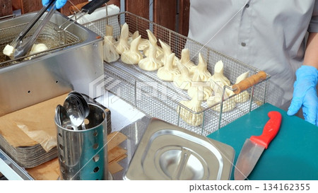 Artisan pastry preparation details, Handcrafted dessert assembly captured with various professional tools, Detailed view of artisanal bakers shaping intricate meringue confections at market stall Artisan pastry preparation details, Handcrafted dessert assembly captured with various professional tools, Detailed view of artisanal bakers shaping intricate meringue confections at market stall 134162355