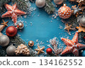 Blue background with red and gold Christmas ornaments. Copy space 134162552