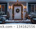White door with wreath is surrounded by Christmas trees and brick walkway 134162556