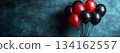Bunch of red and black balloons are floating in the air with copy space 134162557