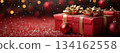 Red Christmas gift box with gold bow on top of it is placed on background with copy space 134162558