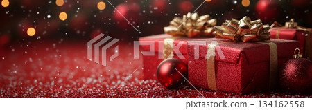 Red Christmas gift box with gold bow on top of it is placed on background with copy space Red Christmas gift box with gold bow on top of it is placed on background with copy space 134162558