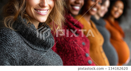 Smiling pregnant women of diverse backgrounds celebrate motherhood together in a joyful moment 134162620